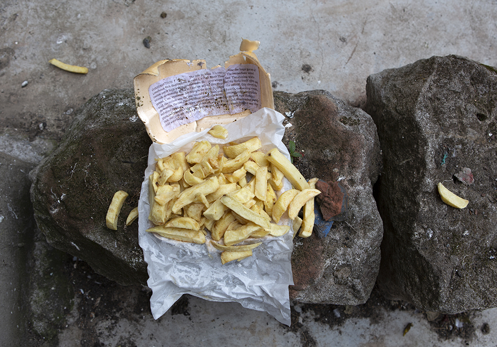 Take away box of chips with script pasted on the inside of the lid