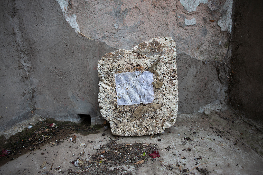 Mouldy bit of polystyrene with script pasted on it